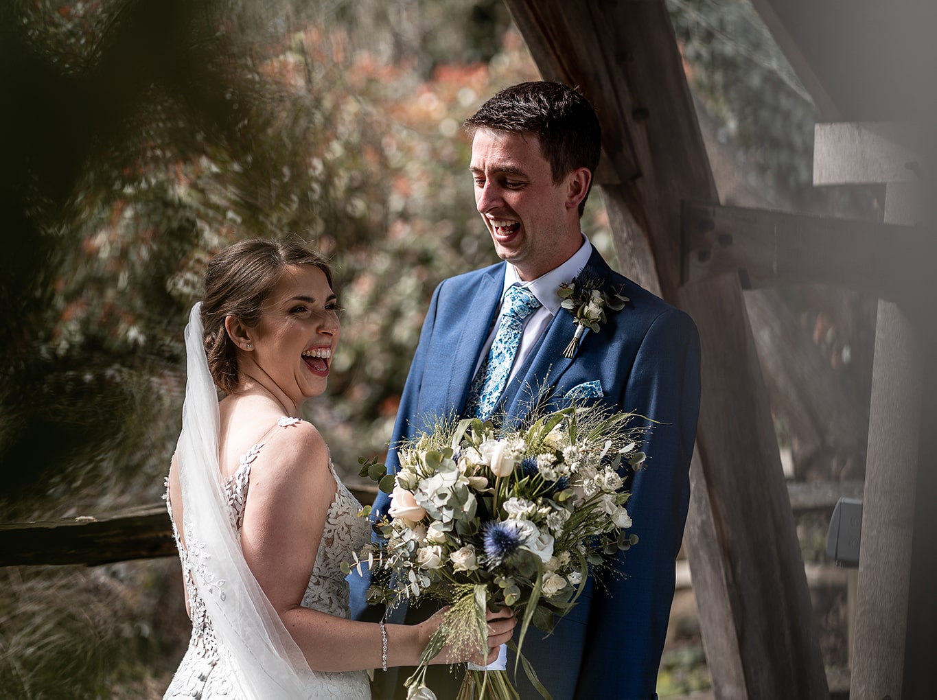 Bride and groom laughing during their photoshoot with wedding photographer Emma Seaney